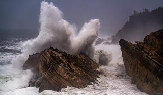 waves exploding on rock at ocean shores state park, oregon